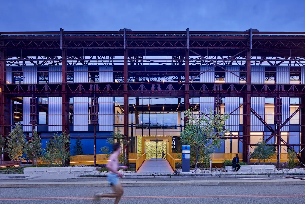 A man jogs past an industrial building
