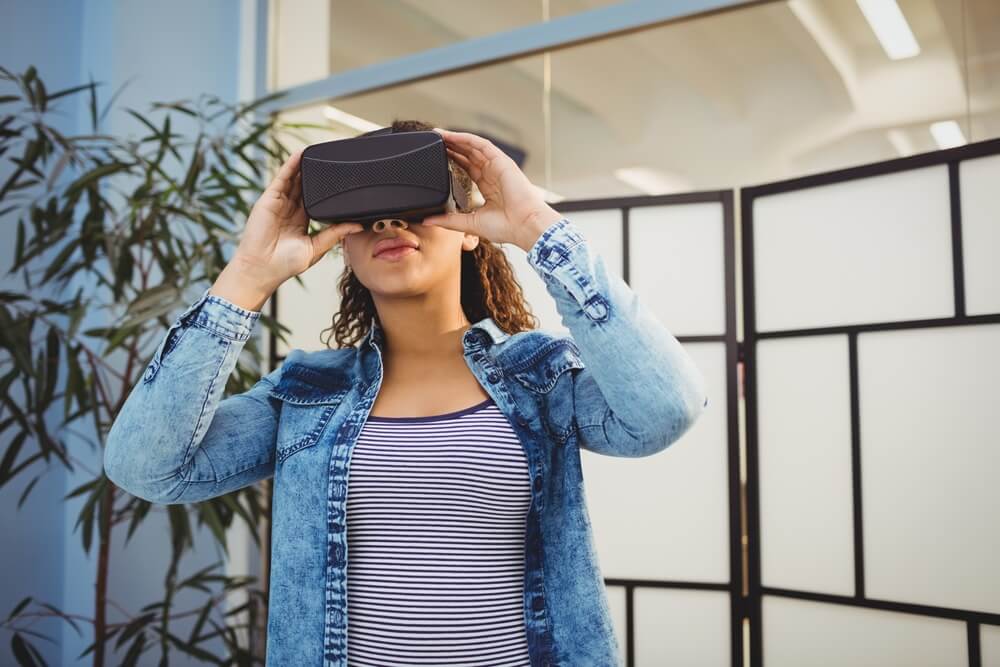 executive enjoying virtual reality headset at creative office