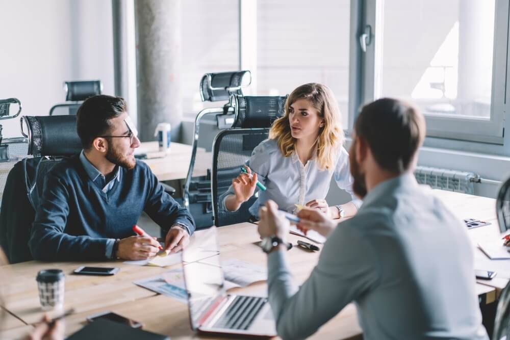 Colleagues working together in office space