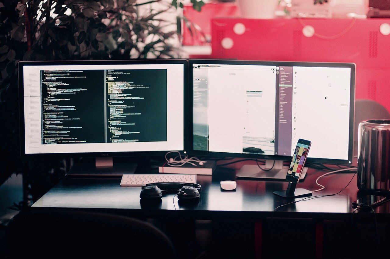 dual computer screens on a desk