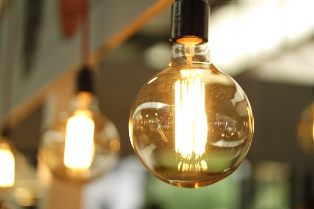 Close-up of glowing vintage-style filament light bulbs with a blurred background.