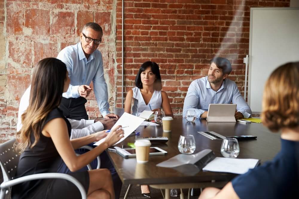 Businesspeople Meeting In Modern Boardroom Through Glass Businesspeople Meeting In Modern Boardroom Through Glass