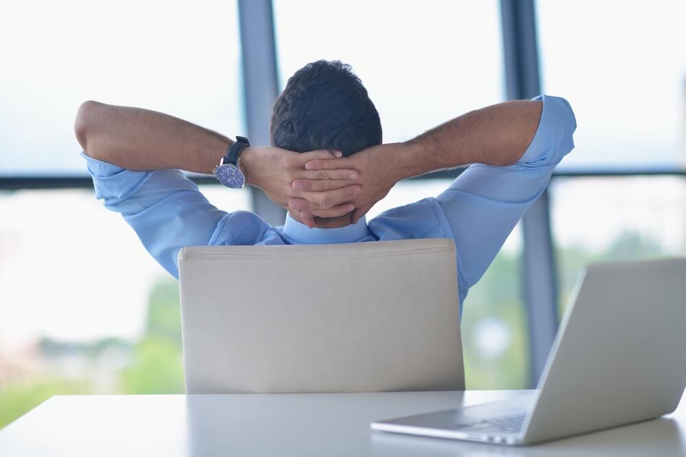 happy young business breathing clean air in office