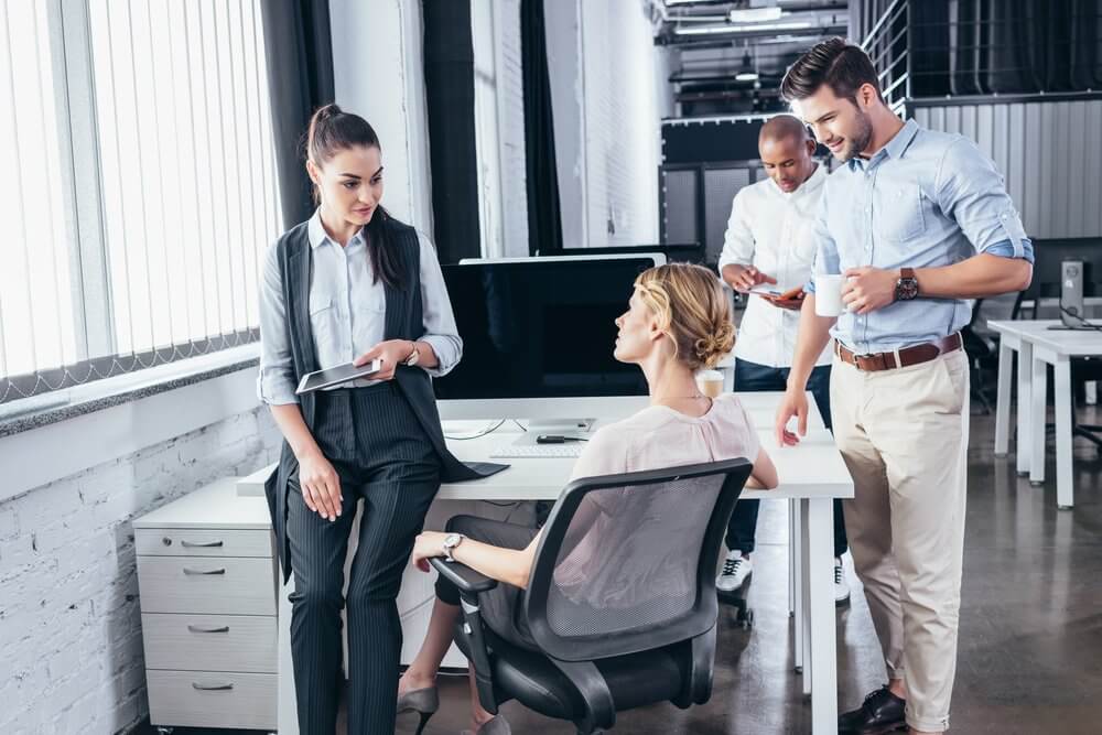 Office employees converse