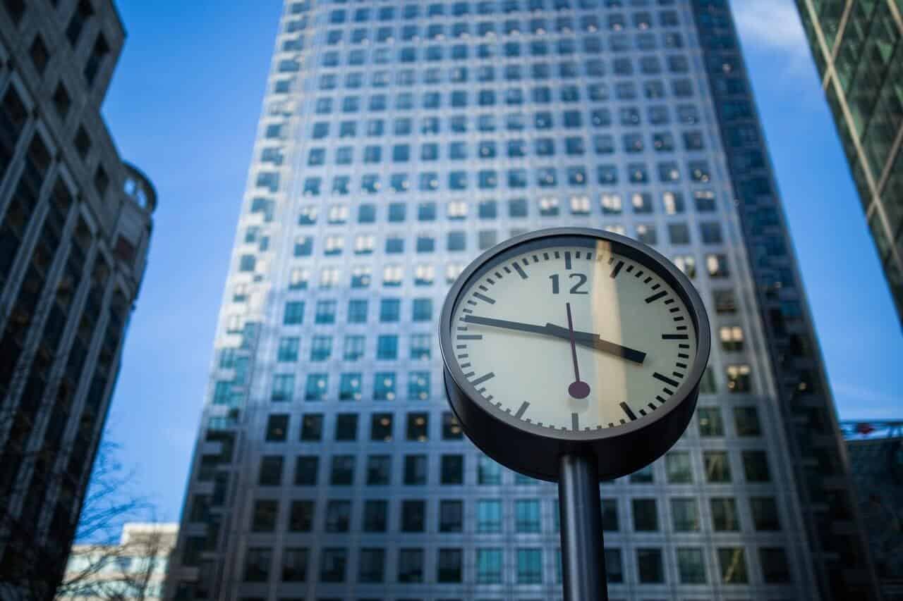 outdoor clock in front of a building outdoor clock in front of a building