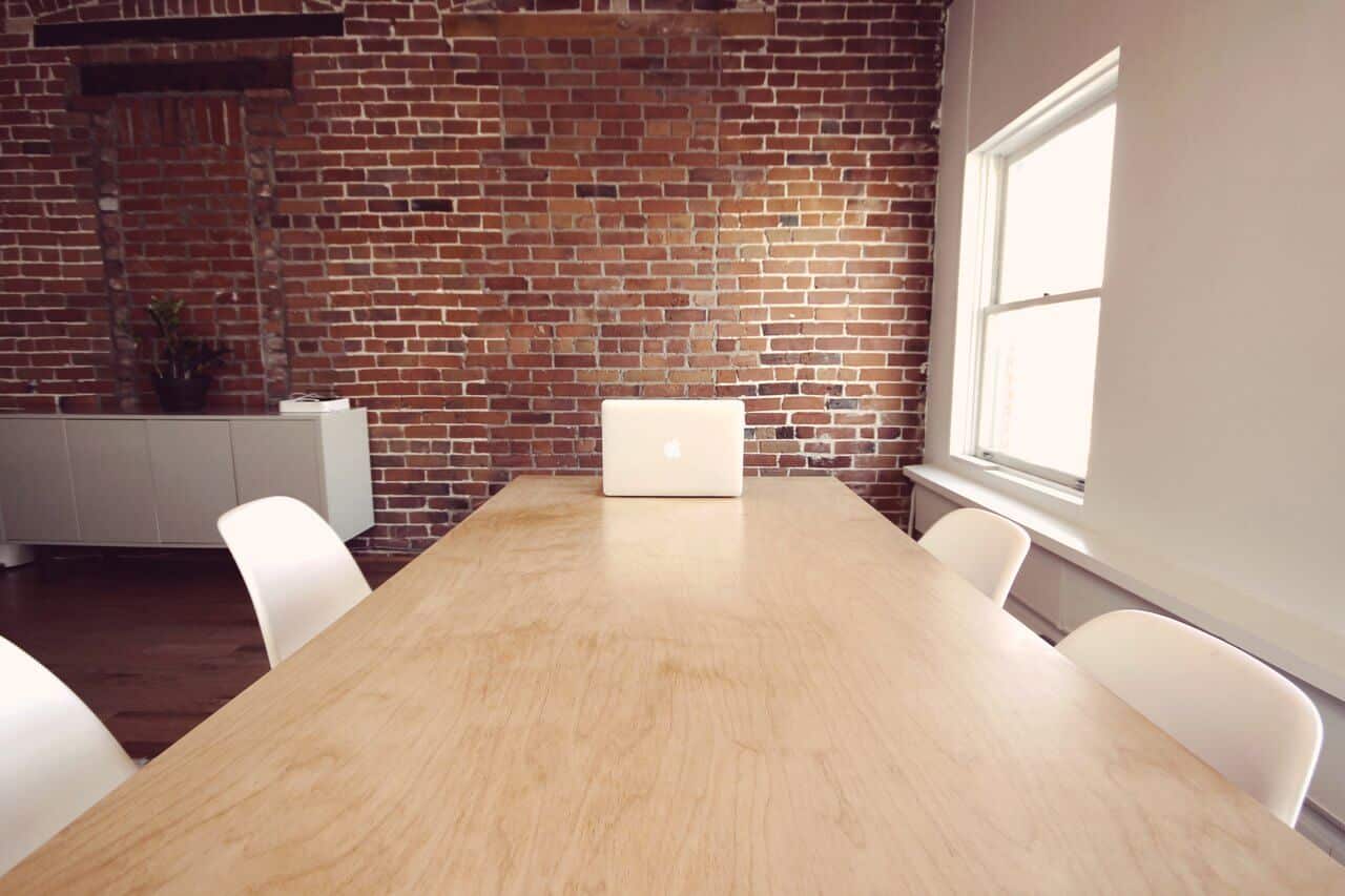 open meeting room with white table and chairs