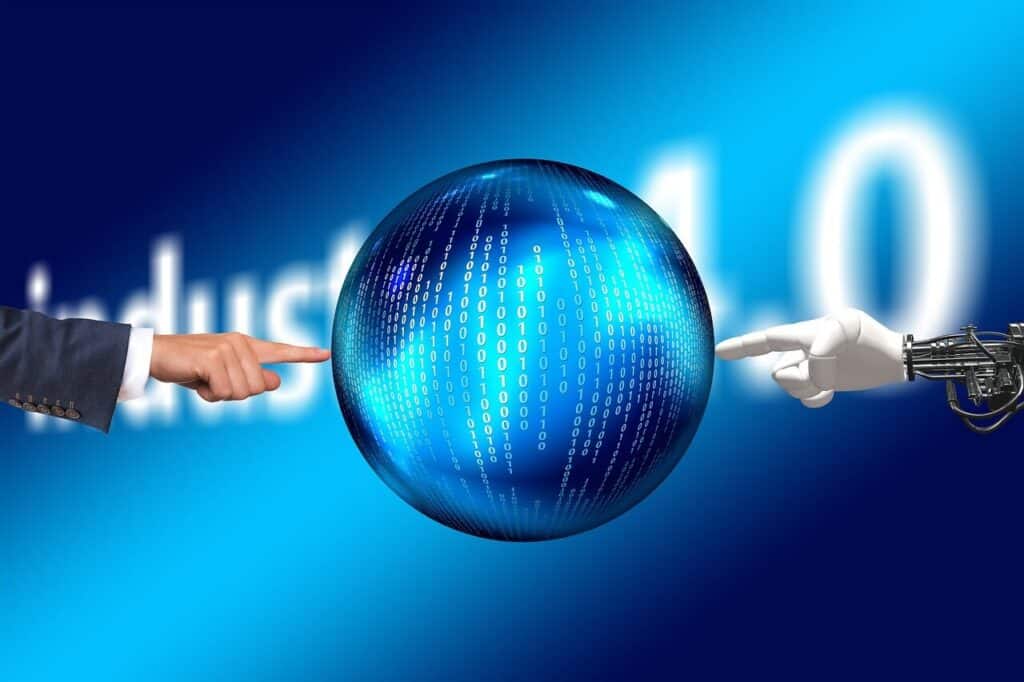Human and robot hands pointing at a digital globe with binary code, against a blurred "industry 4.0" background.