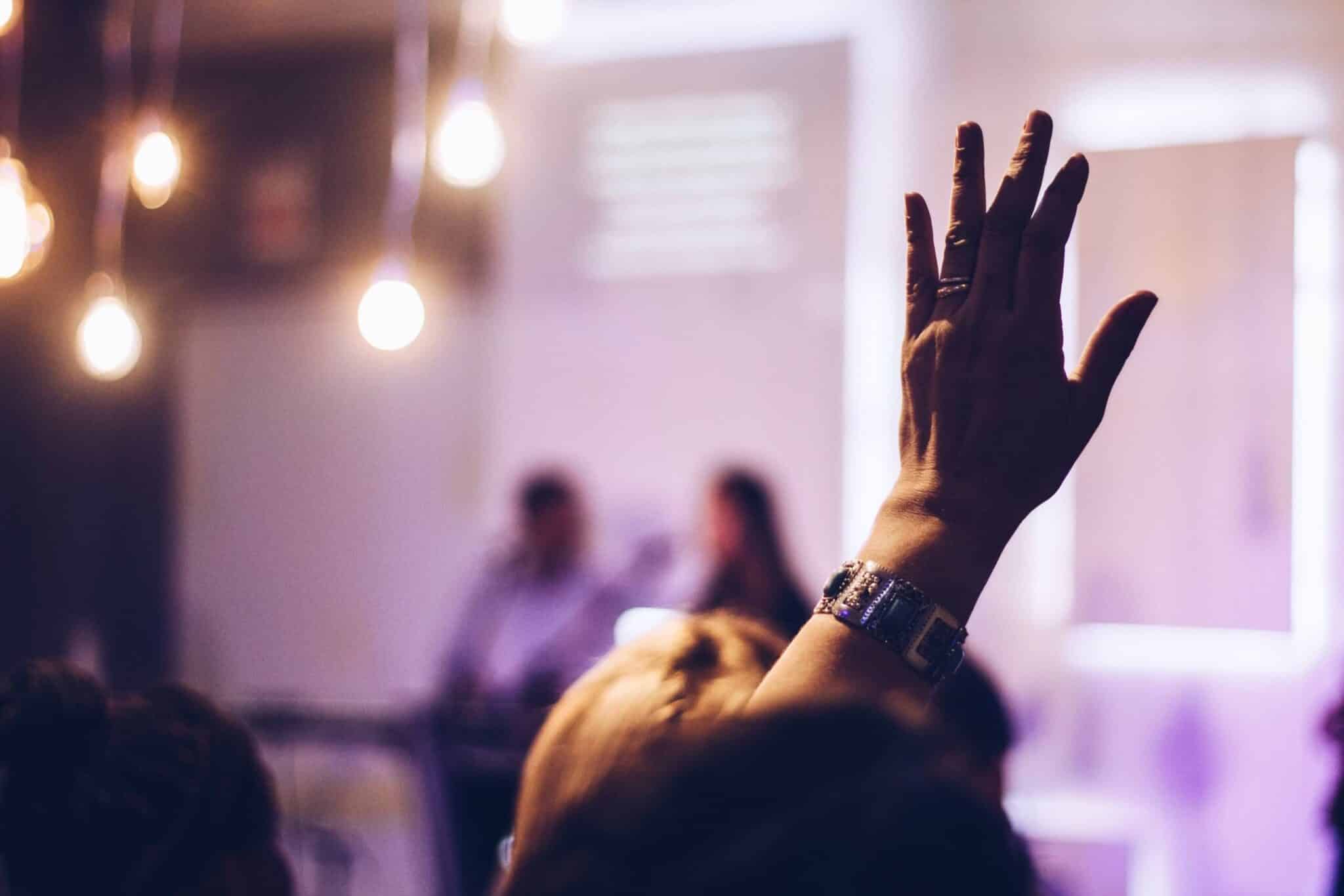 conference participant with raised hand
