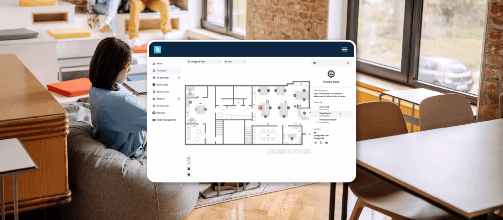 A product shot of Shared Assigned Seating in OfficeSpace with a woman working at desk in the background.