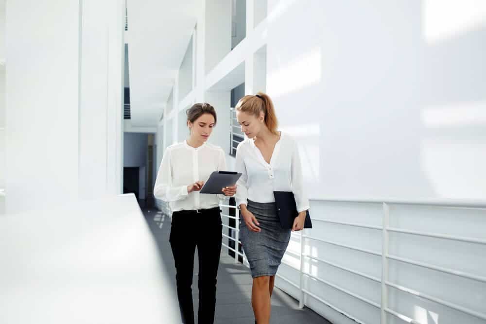 business women talking while implementing communications plan business women talking while implementing communications plan