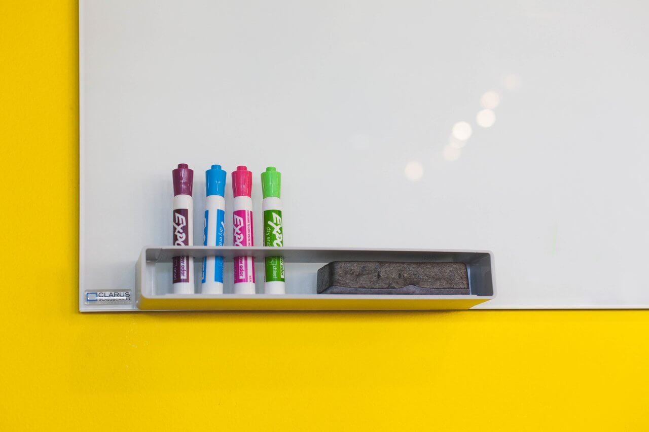 whiteboard with colorful markers