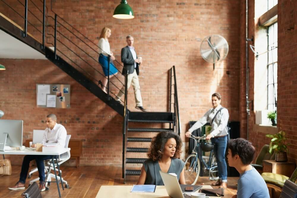 Start of a busy day at work in trendy office with business people Start of a busy day at work in trendy office with business people