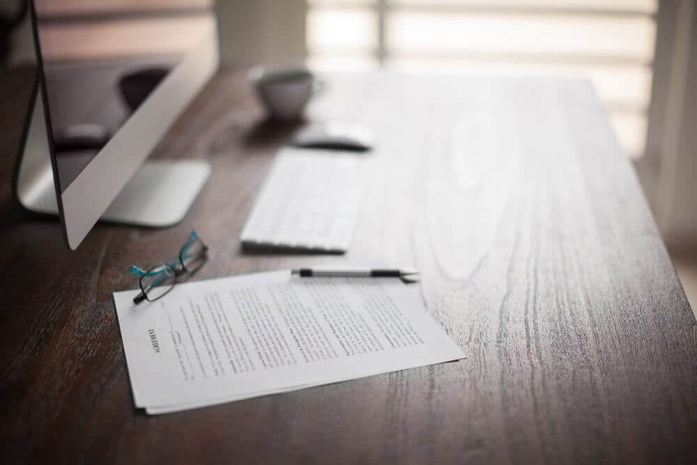 contracts and pen on table contracts and pen on table