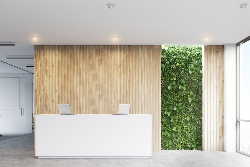 Bright reception area in office space with a plant wall